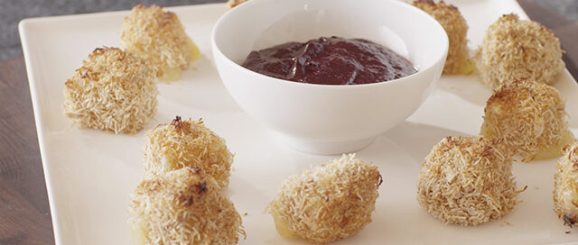 Cheese Croquettes on a white plate with a bowl of