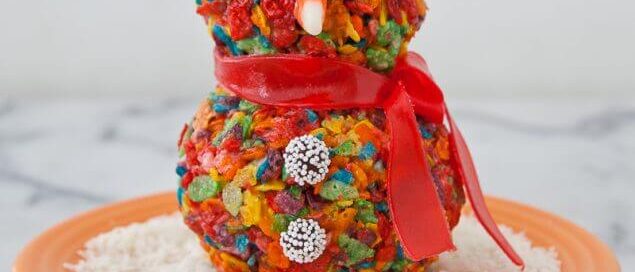 Fruity Pebbles snowman sitting on an orange plate