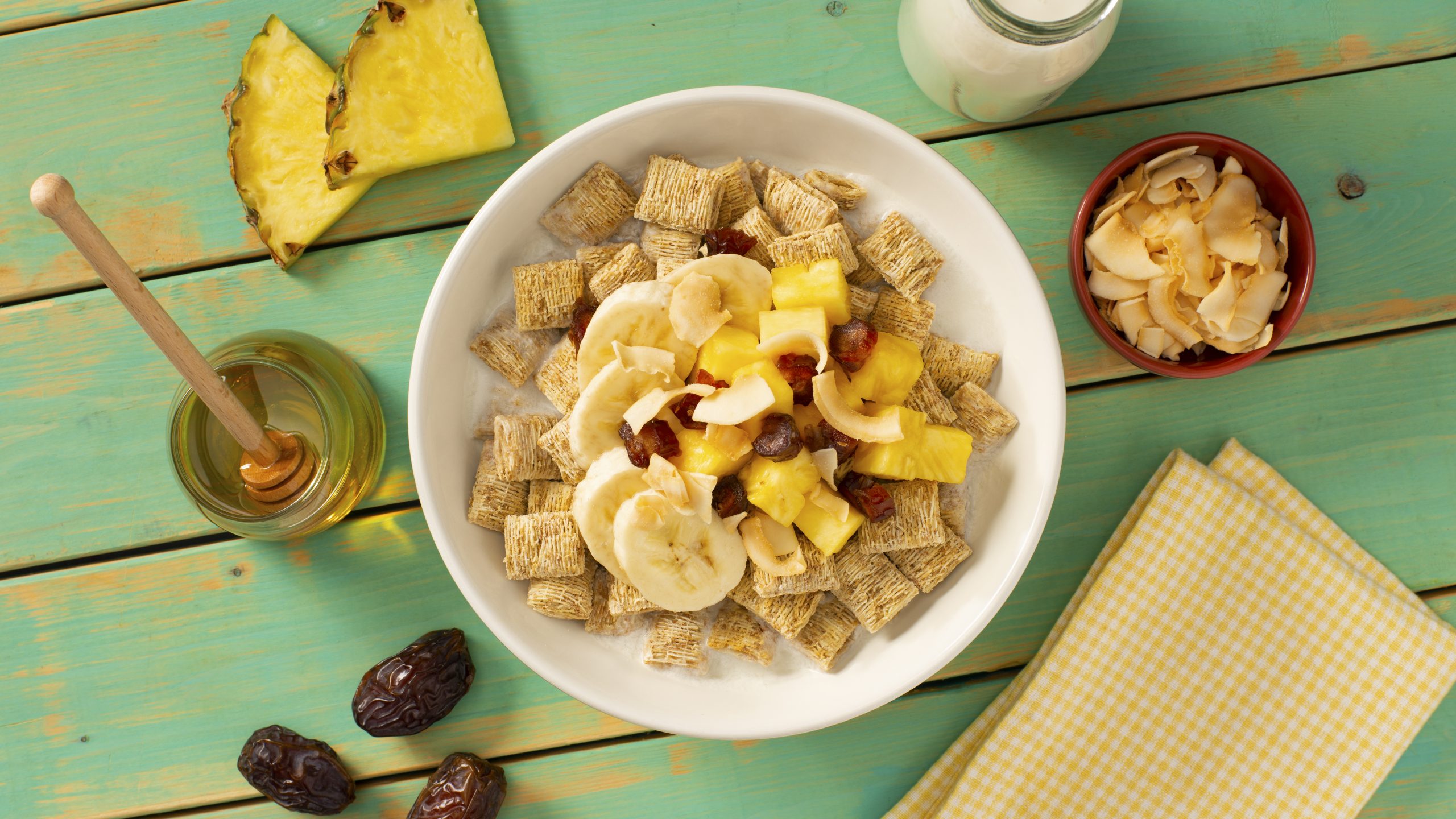 Pina Colada Breakfast Bowl with raisins, banana slices, and pineapple slicers.