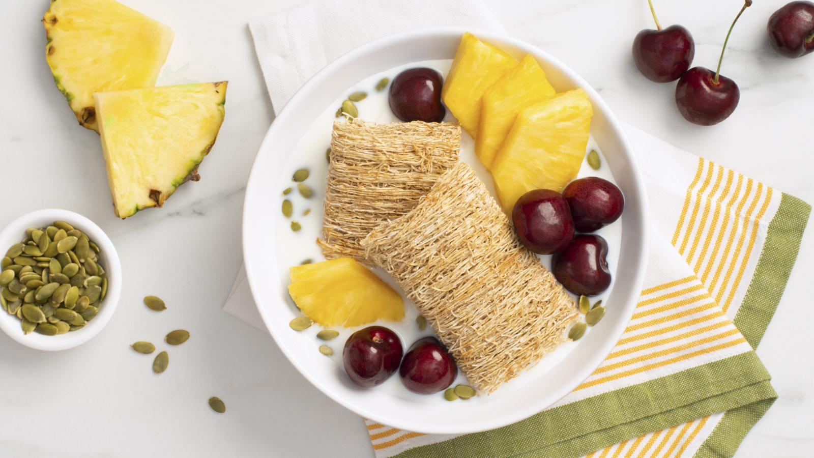 Two Shredded Wheat Biscuits with pineapple slices and cherries.