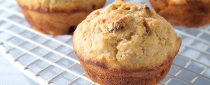 Banana Raisin muffins on a white cooling rack.