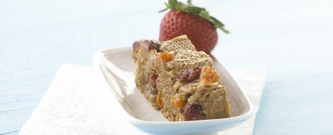 Shreddies Chewy Cereal Bar in a white serving dish with a strawberry on top.