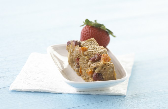 Shreddies Chewy Cereal Bar in a white serving dish with a strawberry on top.