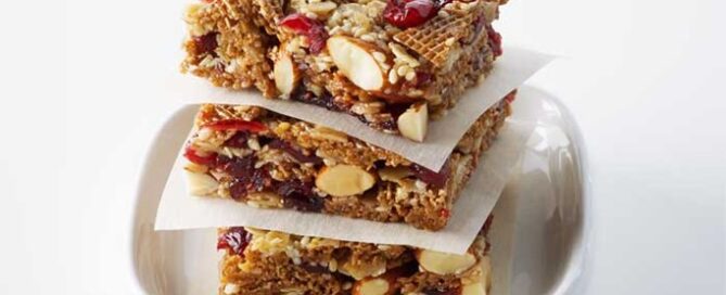 Shreddies Chewy Granola Squares stacked on top of one another in a white serving dish.
