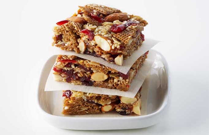 Shreddies Chewy Granola Squares stacked on top of one another in a white serving dish.