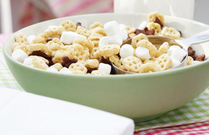 Honeycomb cereal in a green bowl with mini marshmallows and chocolate chips.