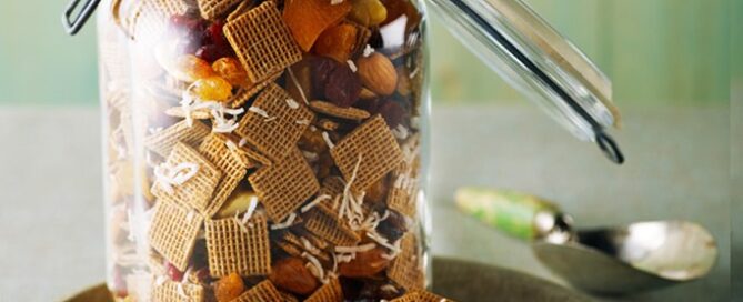 Shreddies No-Bake Trail Mix in a mason jar on a serving plate.