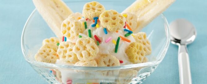 Honeycomb Lickety-Split Crunch in a clear bowl with a spoon on the side.