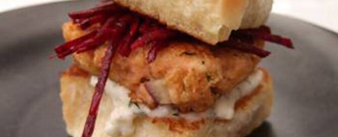 Post Shredded Wheat Salmon Sliders with Fresh Beet Slaw on a black plate.