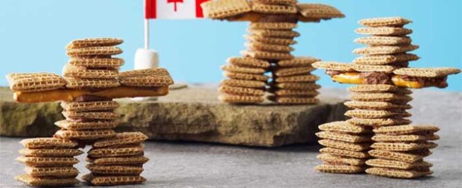 Shreddies Inukshuks on a blue background with a Canadian flag on the side.
