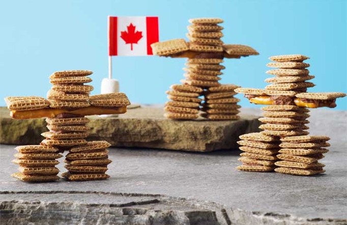 Shreddies Inukshuks on a blue background with a Canadian flag on the side.