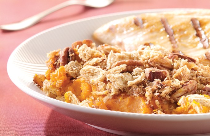 Streusel Baked Winter Squash on a white plate on a pink tablecloth.