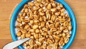 Sugar Crisp Cereal in a blue bowl on a wooden table.