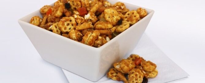 Tropical Caramel Honeycomb Party Mix in a white bowl.