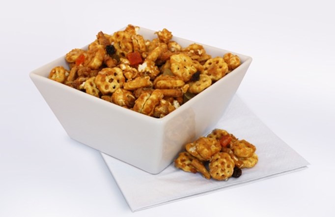 Tropical Caramel Honeycomb Party Mix in a white bowl.