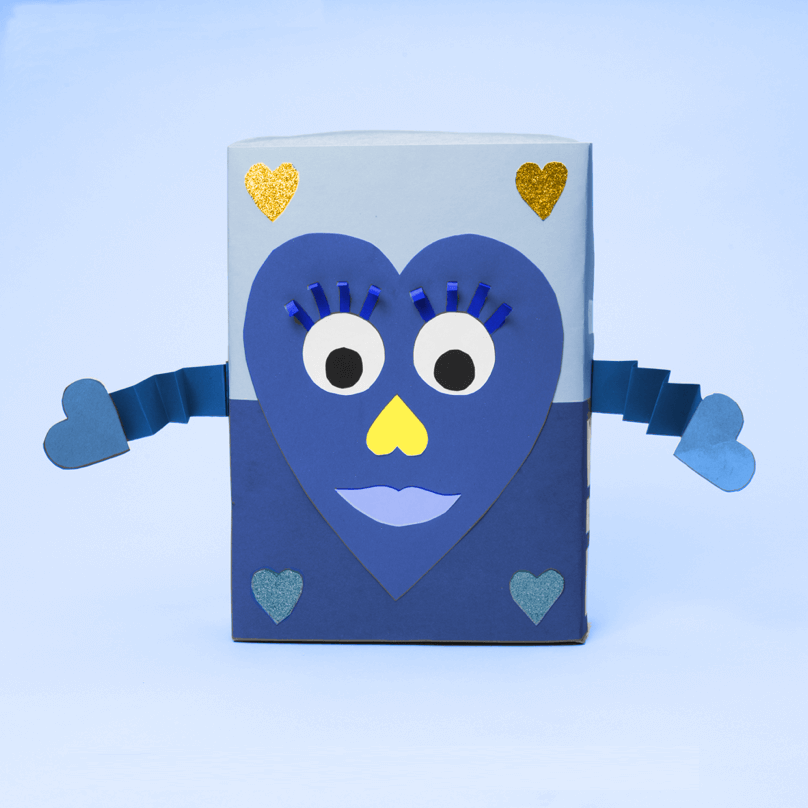 A blue paper heart with a face and arms, glued to a blue cereal box.